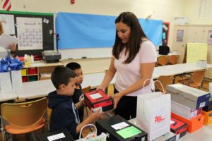 ASi-Networks donating pairs of shoes to children