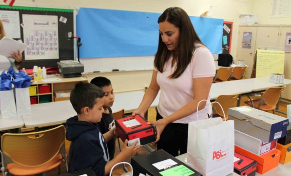ASi-Networks donating pairs of shoes to children