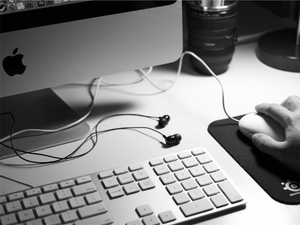 A black and white photo of a desktop with an iMac